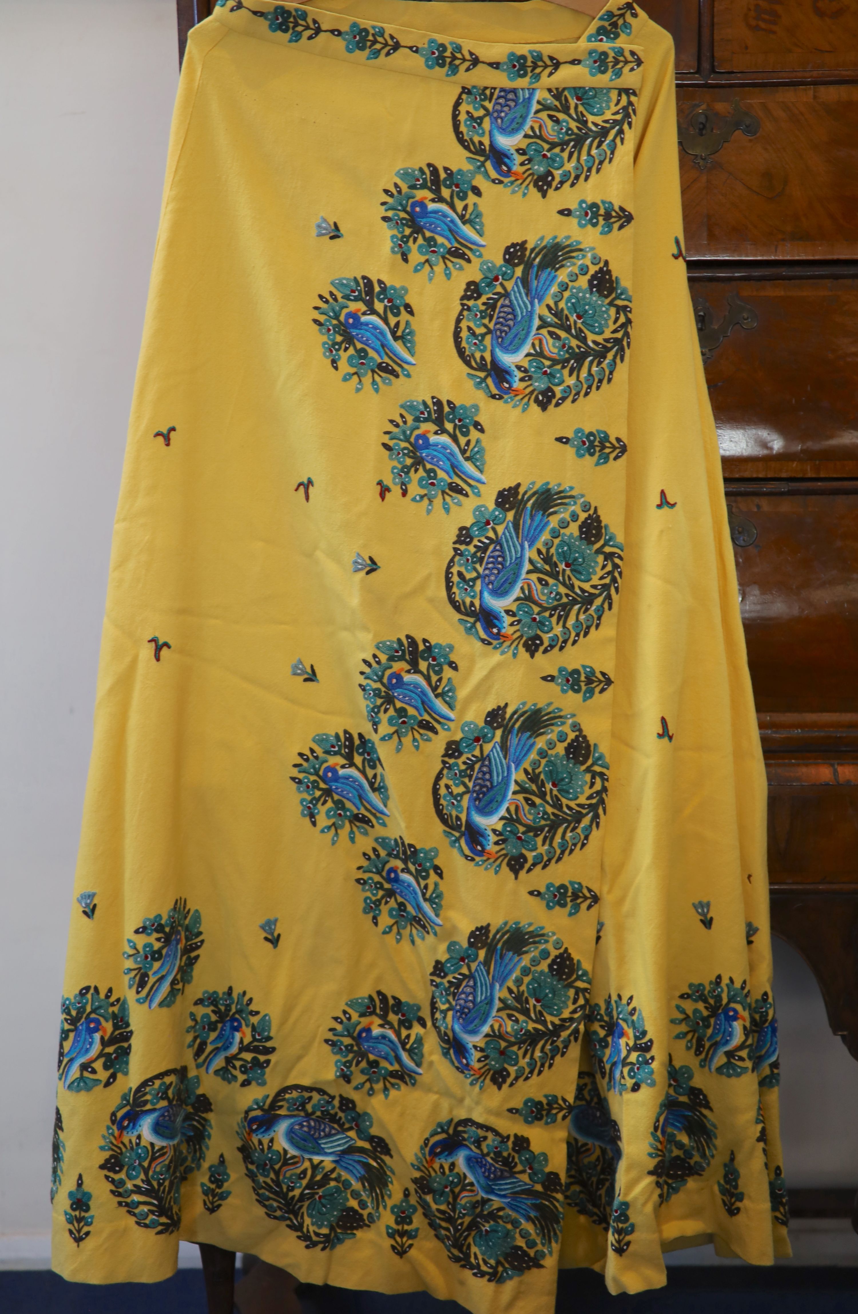 A 1940s silk lurex floral designed evening jacket, trimmed with gold coloured lace and a fine yellow wool skirt,